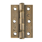 Antique brass knurled lever door handle set with round rose backplates, three matching brass door hinges, tubular latch, strike plate and fixing screws for internal doors.